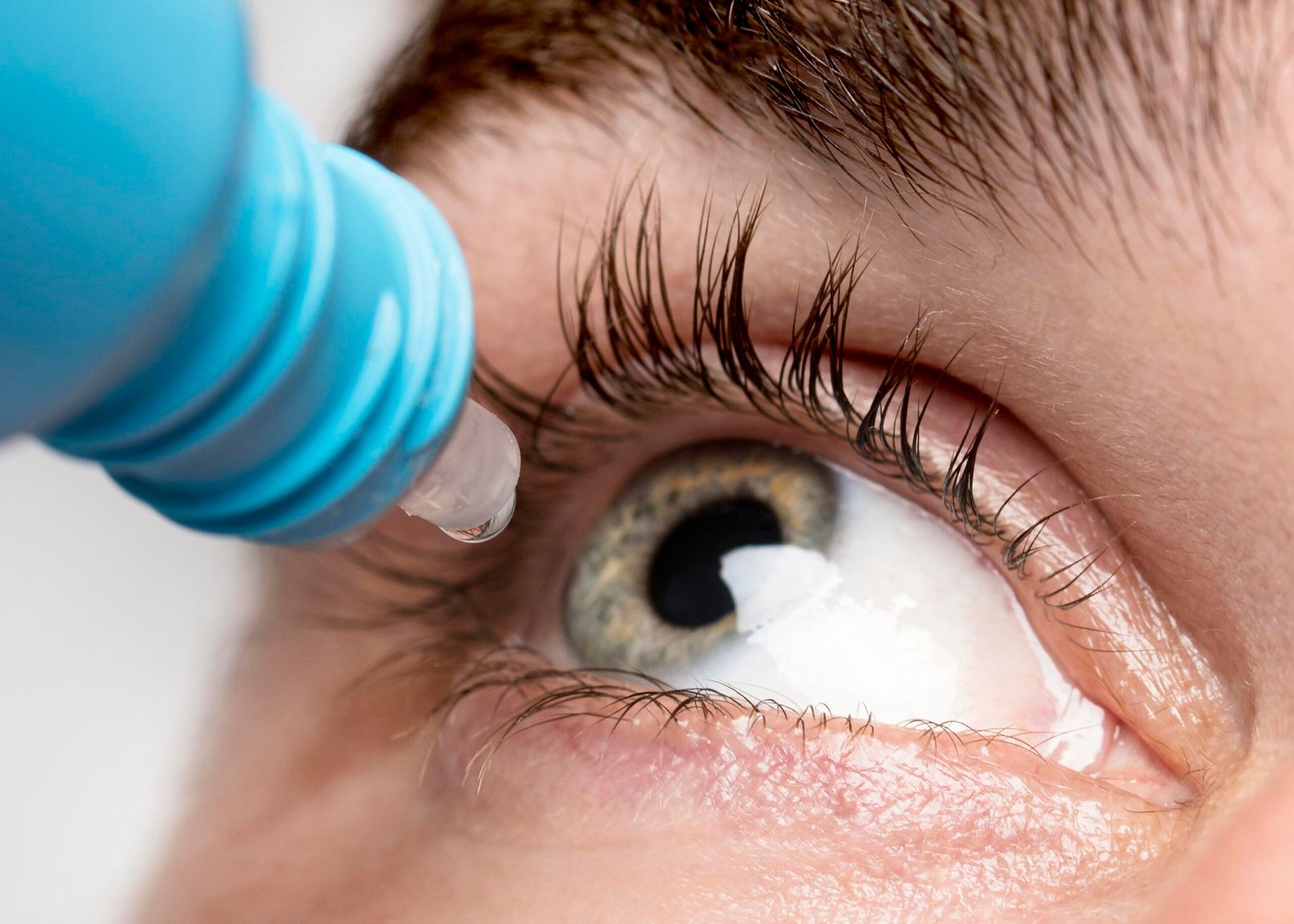 man-using-eye-drops-close-up